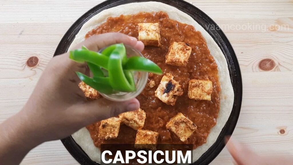 Paneer tikka pizza base apply capsicum