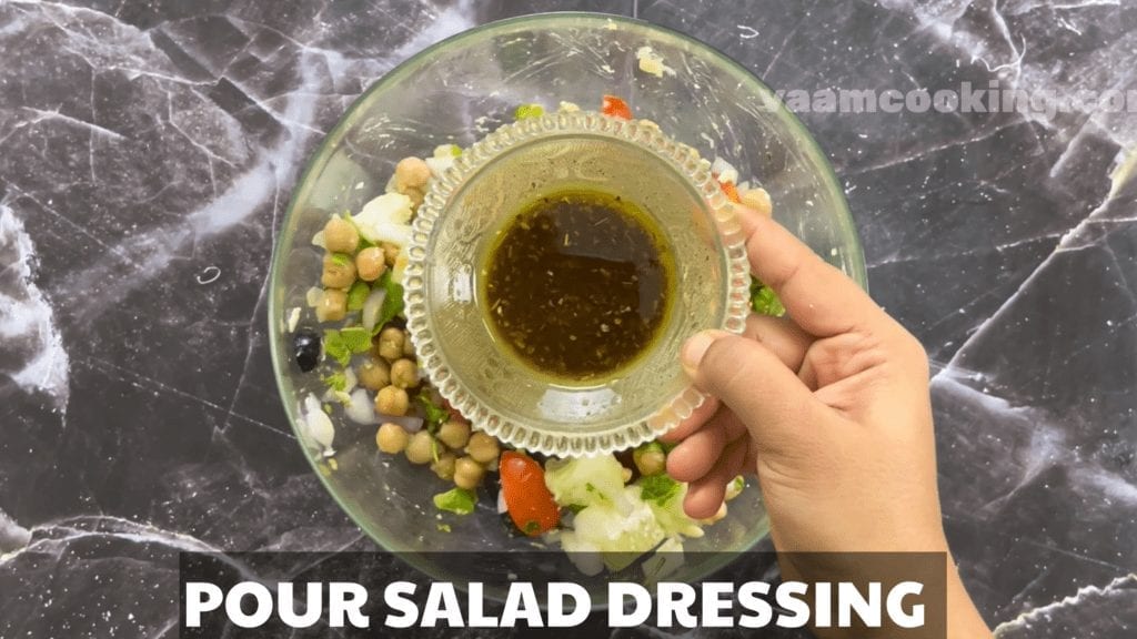 Chickpea Salad Recipe with Avocado pour salad dressing into salad
